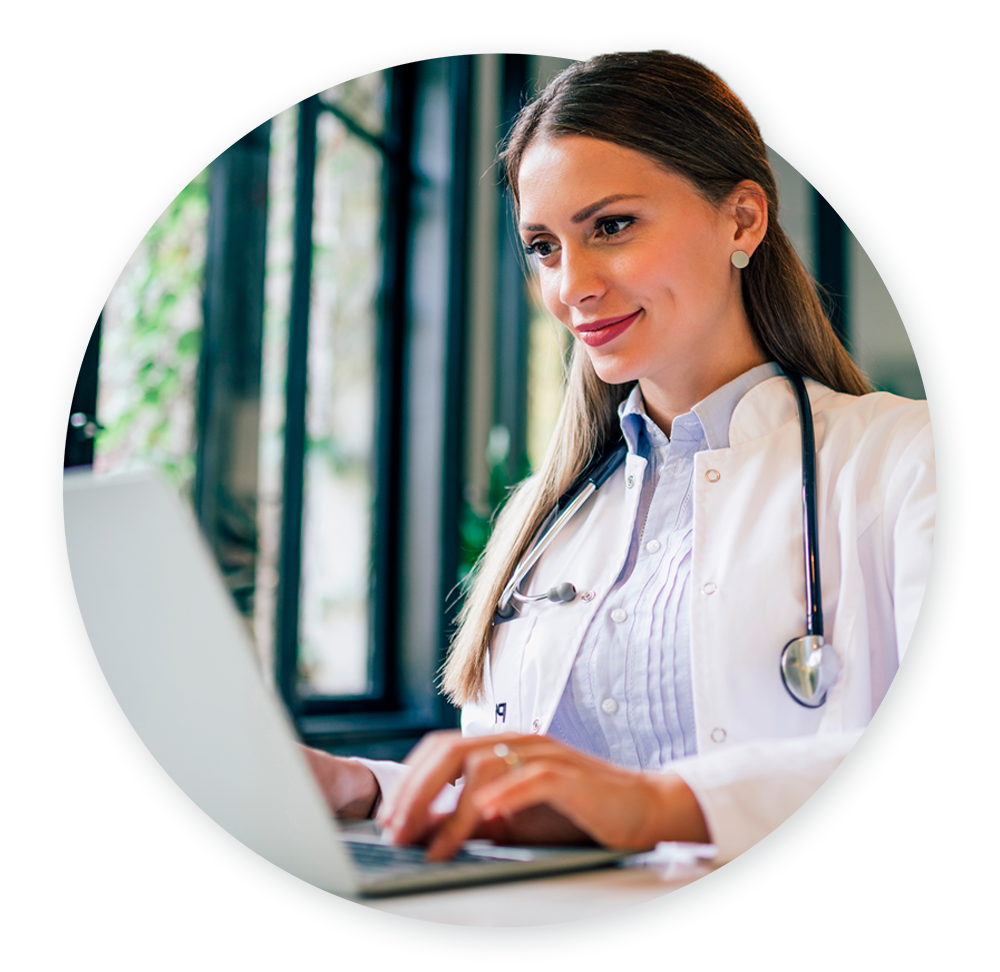 Female doctor sitting at desk on laptop