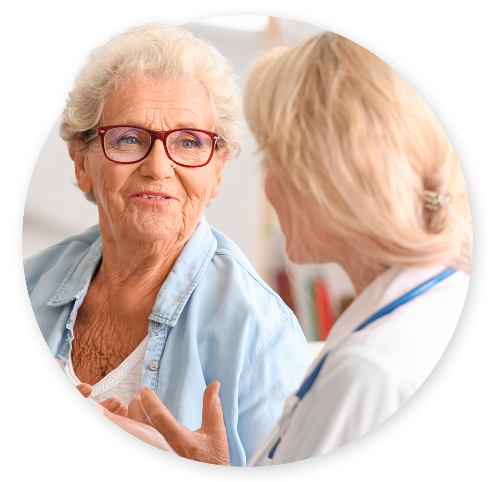 Doctor speaking to elderly patient and gathering SDOH information