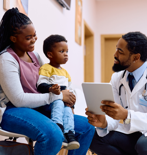 Pediatrician talking to mother and child