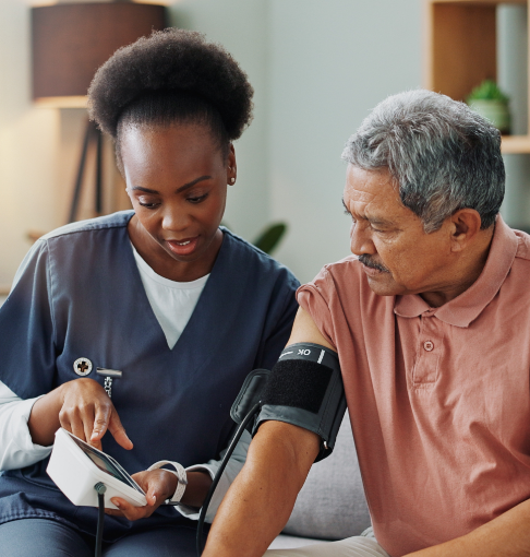 Nurse taking elderly patients blood pressure