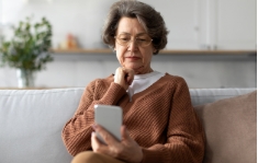 Elderly lady using phone to view HIPAA-compliant form
