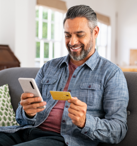 Image of man paying by credit card on his phone