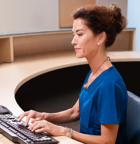 Healthcare employee working at front desk