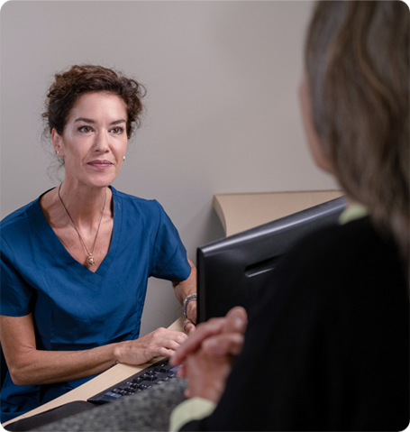 Front desk worker engaging with a patient in lobby