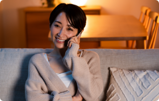 Smiling woman talking on phone to doctor after hours