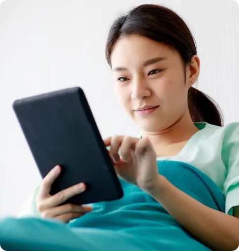 Girl in hospital bed on tablet